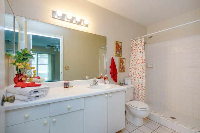 bathroom featuring tile patterned flooring, vanity, toilet, and curtained shower