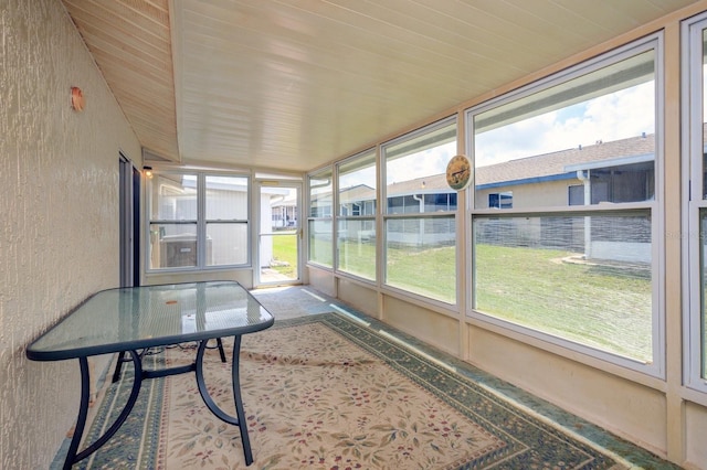 unfurnished sunroom featuring wood ceiling