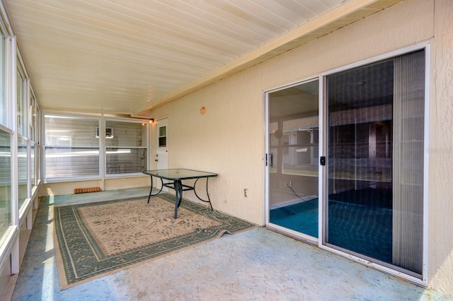 sunroom / solarium with a wealth of natural light and wooden ceiling