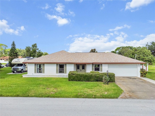 single story home featuring a garage and a front lawn