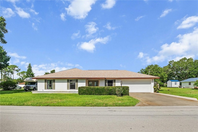 ranch-style house featuring a garage and a front lawn