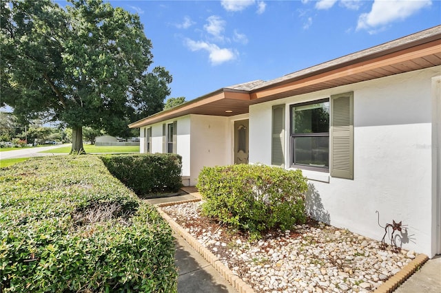 doorway to property featuring a yard