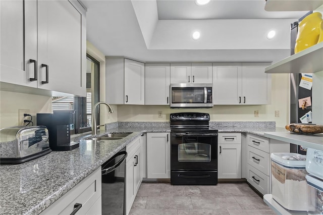 kitchen featuring black appliances, white cabinetry, and sink