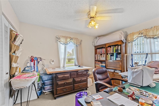 home office with ceiling fan, light carpet, and a textured ceiling