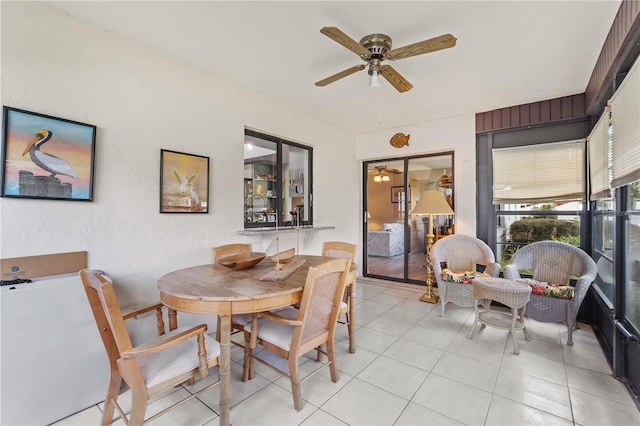 tiled dining room with ceiling fan