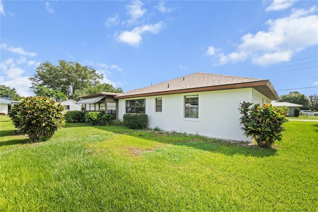 rear view of property with a yard