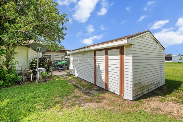 view of outbuilding with a yard