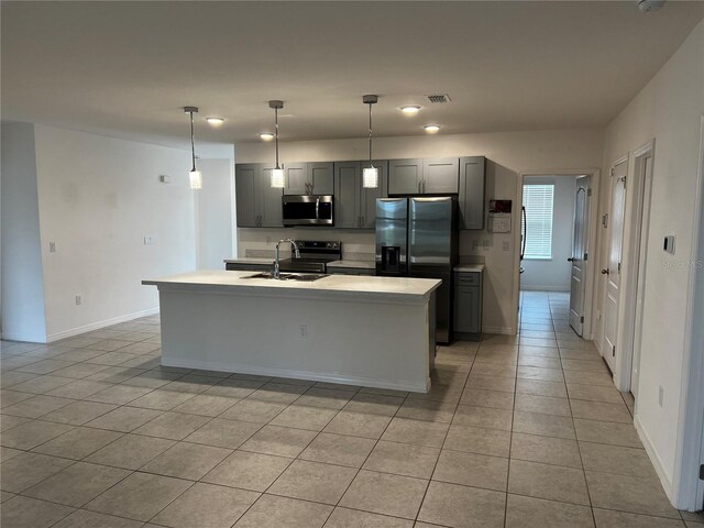 177 Cimarron Ln, Kissimmee, FL 34759 - kitchen with stainless steel appliances, a sink, light tile patterned floors, light countertops, and gray cabinetry