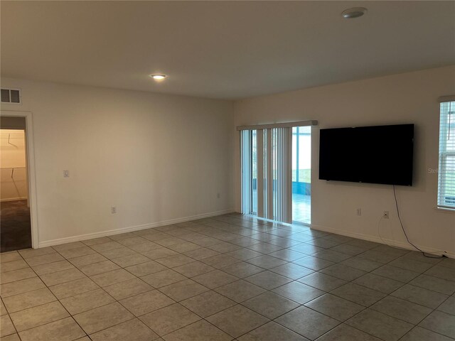177 Cimarron Ln, Kissimmee, FL 34759 - empty room featuring light tile patterned flooring, plenty of natural light, baseboards, and recessed lighting
