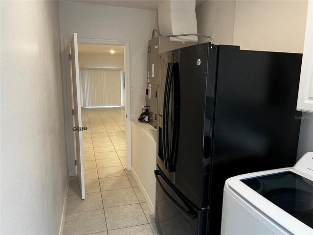 177 Cimarron Ln, Kissimmee, FL 34759 - kitchen featuring range, light tile patterned floors, freestanding refrigerator, and baseboards