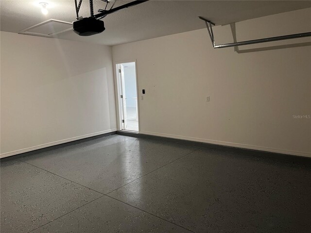 177 Cimarron Ln, Kissimmee, FL 34759 - garage featuring a garage door opener and baseboards
