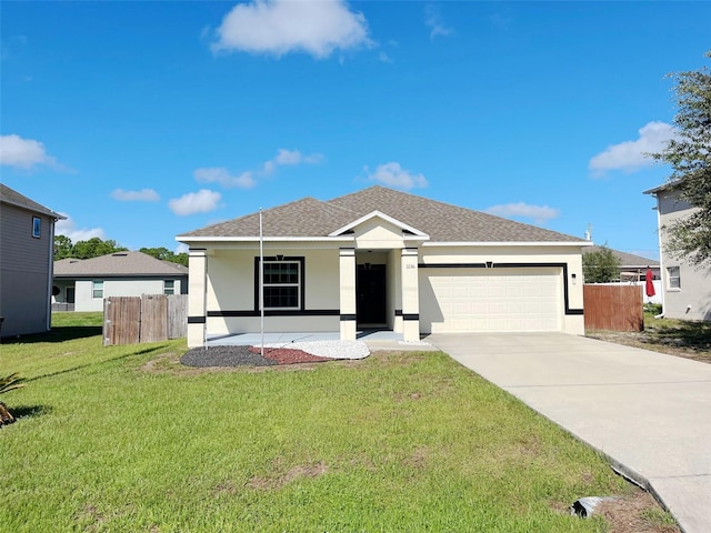 view of front of home featuring a front yard and a garage