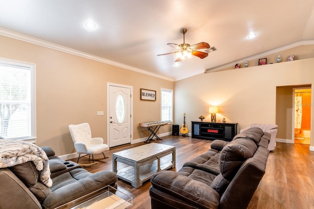 living room featuring vaulted ceiling, ornamental molding, wood-type flooring, and ceiling fan