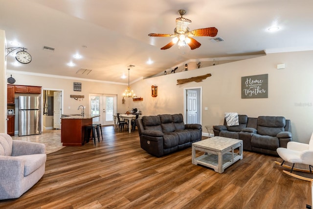 living room featuring ceiling fan with notable chandelier, crown molding, dark hardwood / wood-style flooring, sink, and lofted ceiling