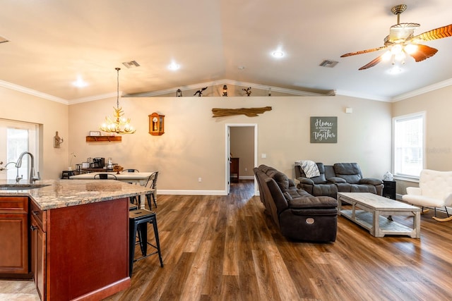 interior space with ceiling fan with notable chandelier, dark hardwood / wood-style floors, ornamental molding, and sink