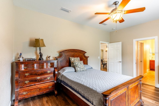 bedroom featuring ensuite bath, wood-type flooring, and ceiling fan