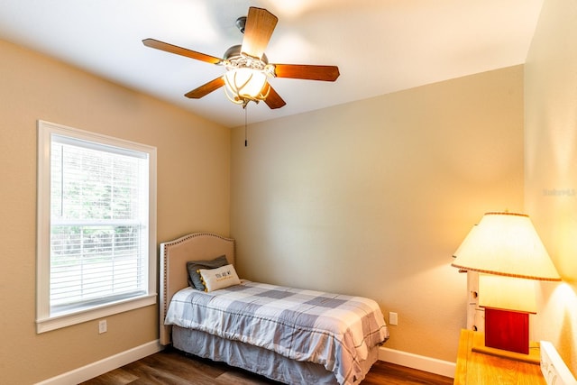 bedroom with ceiling fan and dark hardwood / wood-style flooring