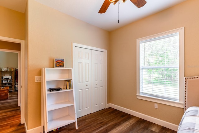 bedroom with a closet, ceiling fan, and dark hardwood / wood-style flooring