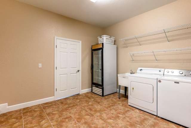 laundry room with independent washer and dryer and sink