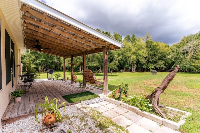 view of yard featuring ceiling fan and a wooden deck