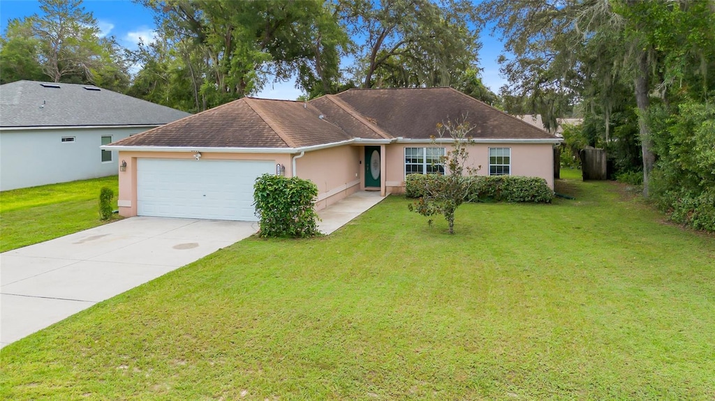 single story home with a garage and a front yard