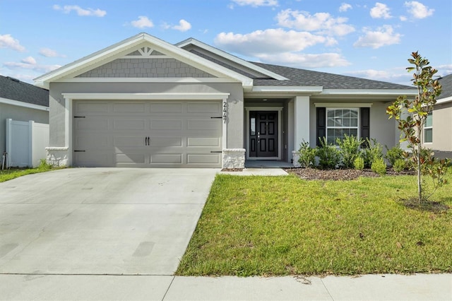 view of front of home with a garage and a front yard