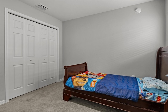 carpeted bedroom with a closet