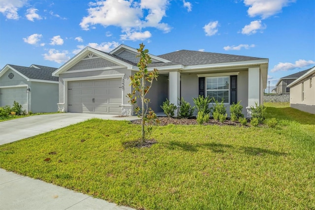 view of front of property featuring a garage and a front yard