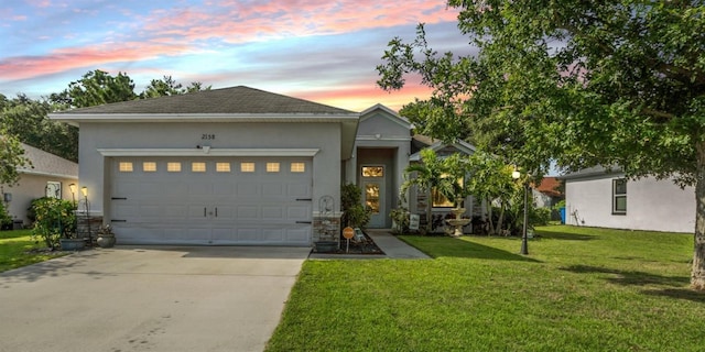 view of front of property featuring a lawn and a garage