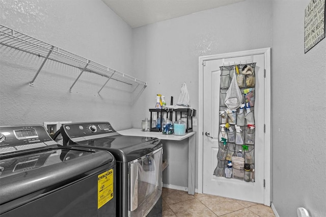 washroom with washer and dryer and light tile patterned flooring