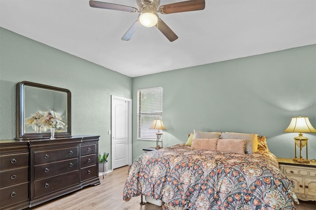 bedroom with ceiling fan and light hardwood / wood-style floors