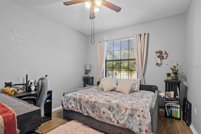 2158 Mirasol Dr, Winter Haven, FL 33881 - bedroom featuring wood finished floors and ceiling fan