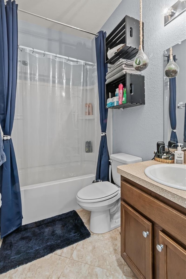 full bathroom featuring tile patterned floors, vanity, toilet, and shower / bath combo with shower curtain