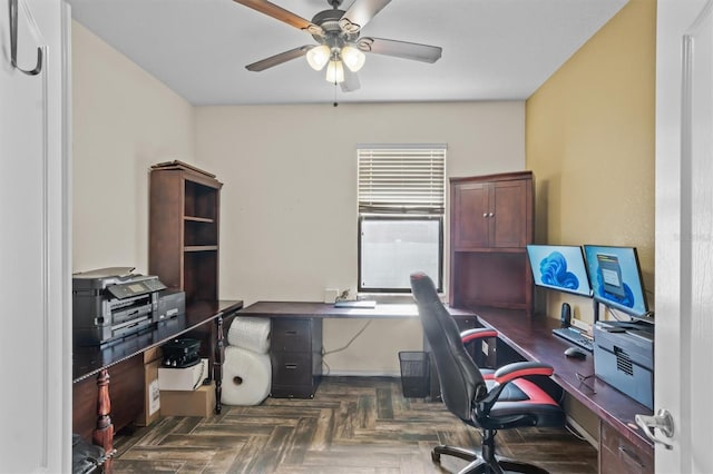 office area with dark parquet floors and ceiling fan