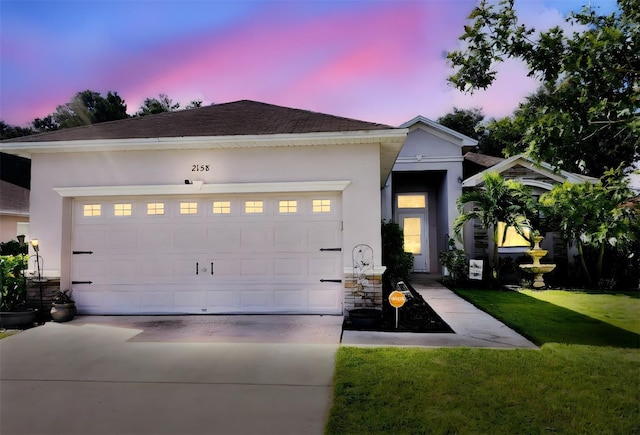 view of front facade featuring a lawn and a garage