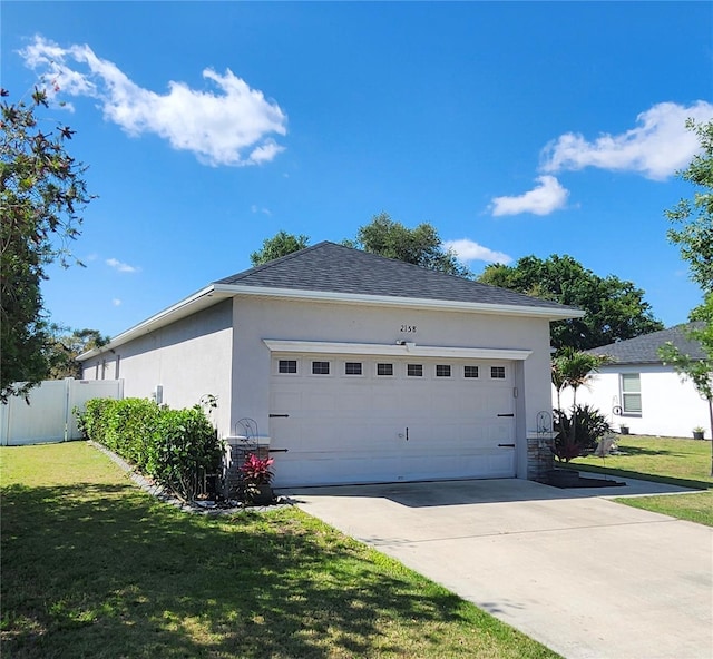 view of property exterior with fence, concrete driveway, a yard, and stucco siding