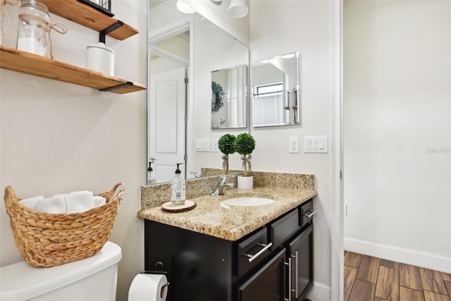 bathroom featuring vanity, toilet, and hardwood / wood-style floors