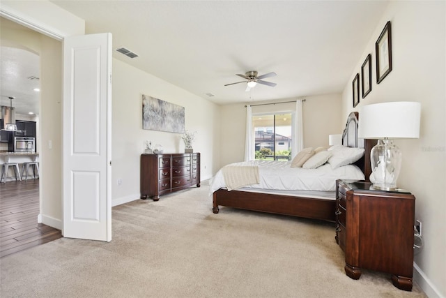 bedroom with ceiling fan and light hardwood / wood-style floors