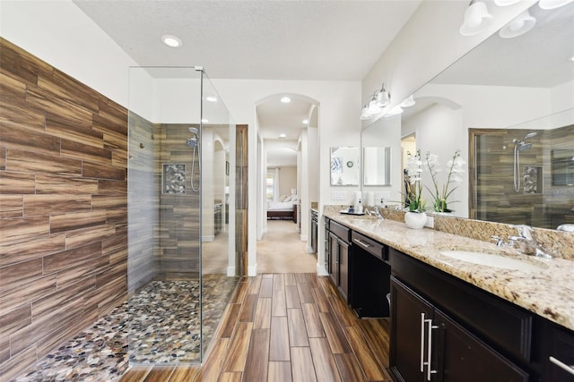 bathroom featuring vanity and a tile shower