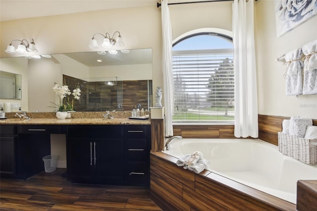 bathroom featuring vanity, separate shower and tub, and hardwood / wood-style flooring