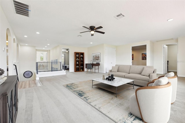 carpeted living room featuring ceiling fan