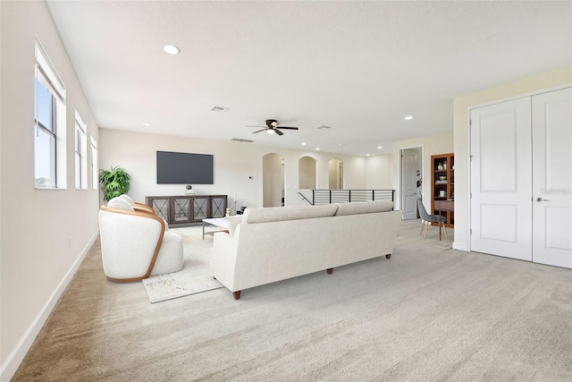 carpeted living room featuring ceiling fan