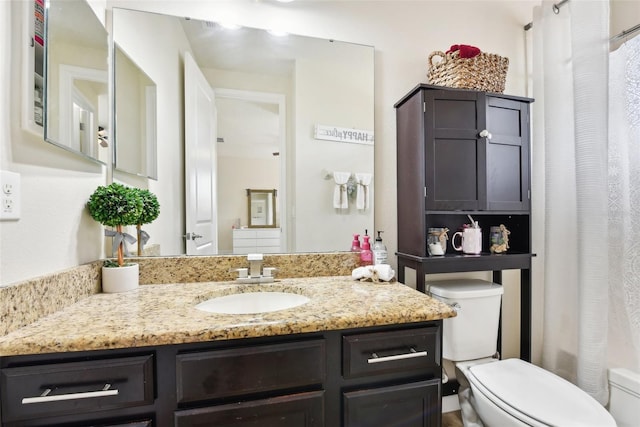 bathroom featuring a shower with curtain, toilet, and vanity