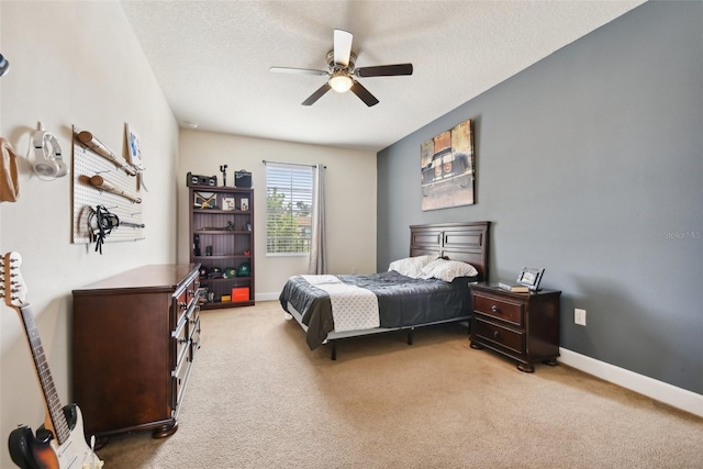 carpeted bedroom featuring a textured ceiling and ceiling fan