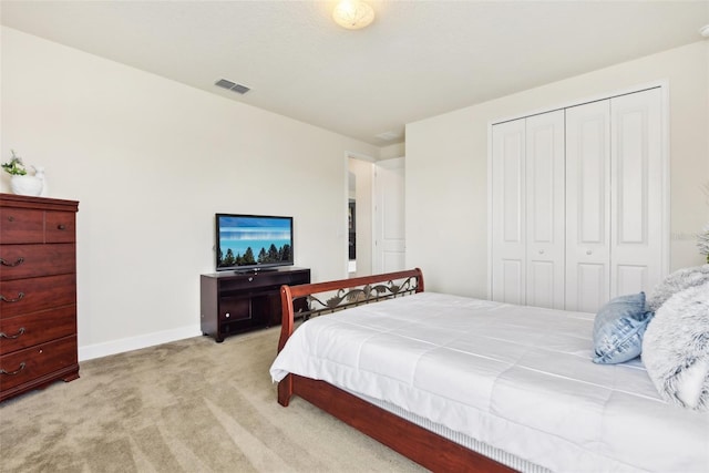 bedroom with light colored carpet and a closet