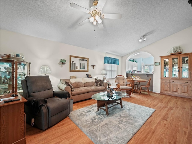 living room with a healthy amount of sunlight, ceiling fan, and light hardwood / wood-style floors