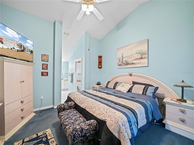 bedroom featuring ensuite bath, lofted ceiling, dark colored carpet, and ceiling fan