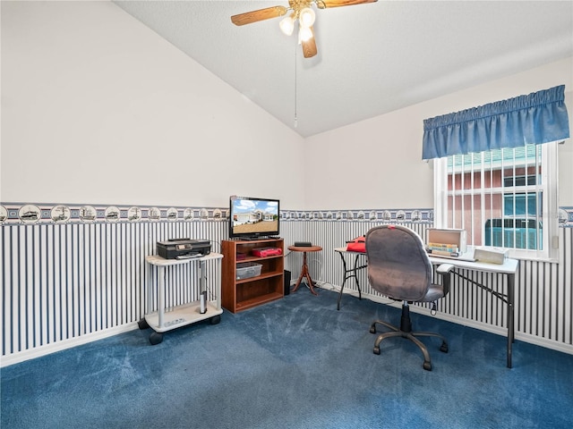 carpeted home office featuring ceiling fan, a textured ceiling, and vaulted ceiling