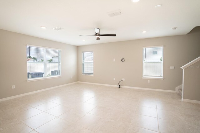 unfurnished room with ceiling fan and light tile patterned floors