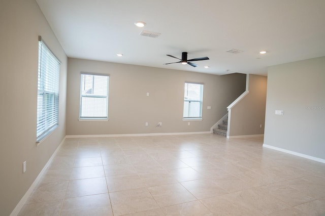 tiled empty room featuring a wealth of natural light and ceiling fan